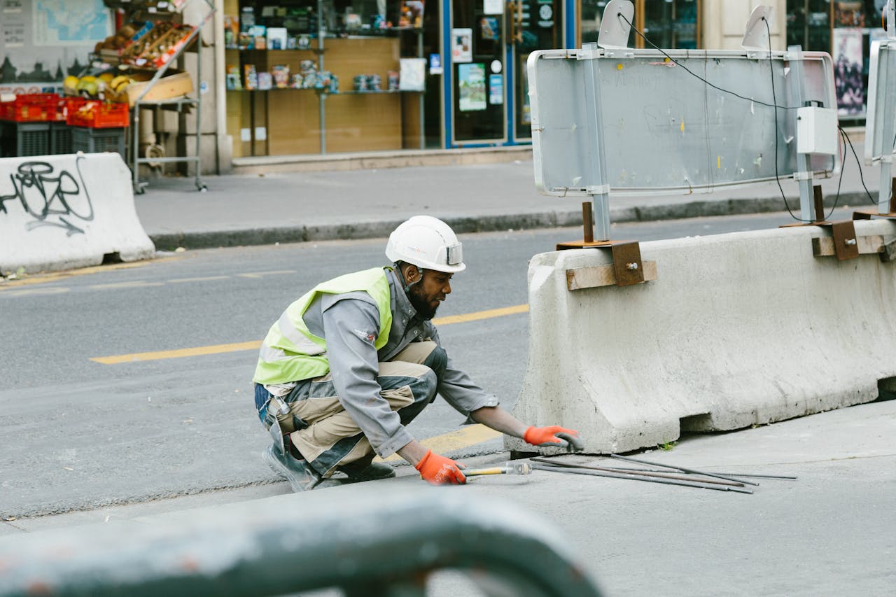 services-04 A construction worker operates on a city street in Paris, France, showcasing urban development.